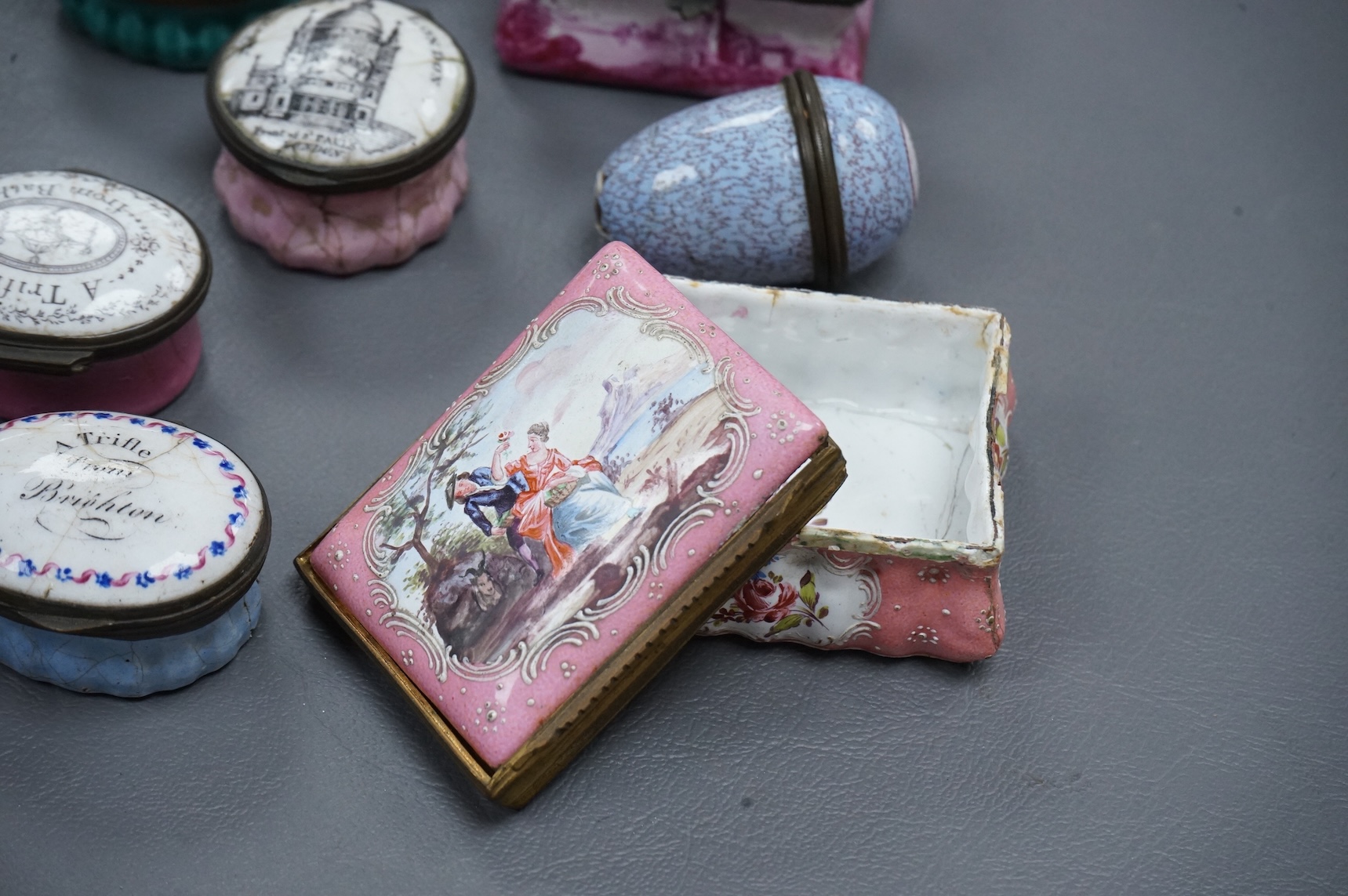 A collection of seven late 18th / early 19th century South Staffordshire enamel patch and snuff boxes and a continental porcelain snuff box, Largest 3.5cm high (8)